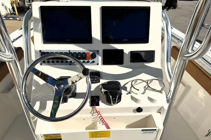 Slide: The Image of 2025 Key West 239 FS boat dashboard with steering wheel and electronic displays. - 34