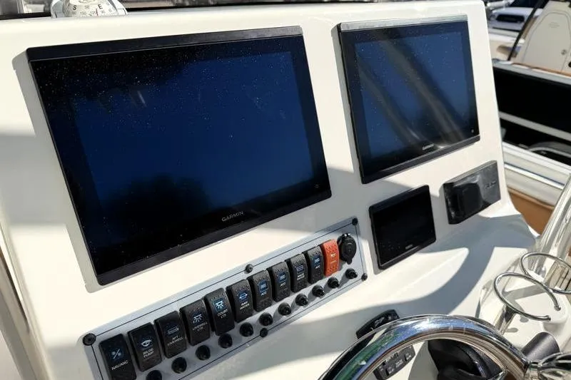Slide: The Image of 2025 Key West 239 FS boat dashboard with dual Garmin displays and control panel. - 35