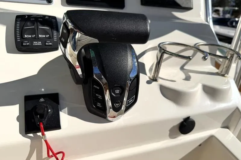 Slide: The Image of 2025 Key West 239 FS boat controls with throttle and cup holder. - 36