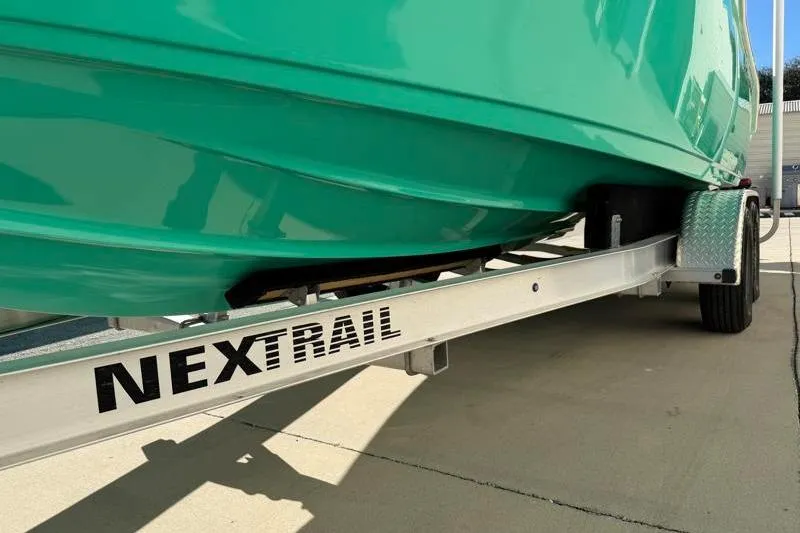 Slide: The Image of 2025 Key West 239 FS boat on Nextrail trailer, vibrant green hull. - 49