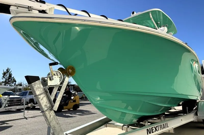 Slide: The Image of 2025 Key West 239 FS boat on trailer, vibrant teal hull, sunny day. - 8