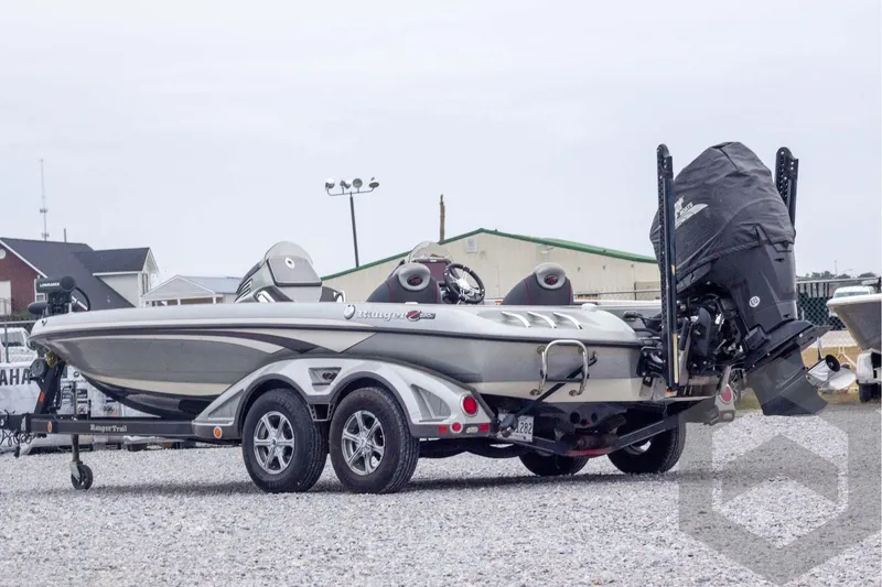 Slide: The Image of 2014 Ranger Z520 Comanche boat on trailer, parked on gravel lot. - 10