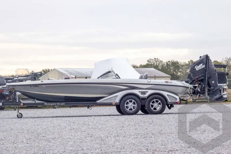 Slide: The Image of 2014 Ranger Z520 Comanche boat on trailer, parked outdoors on gravel. - 12
