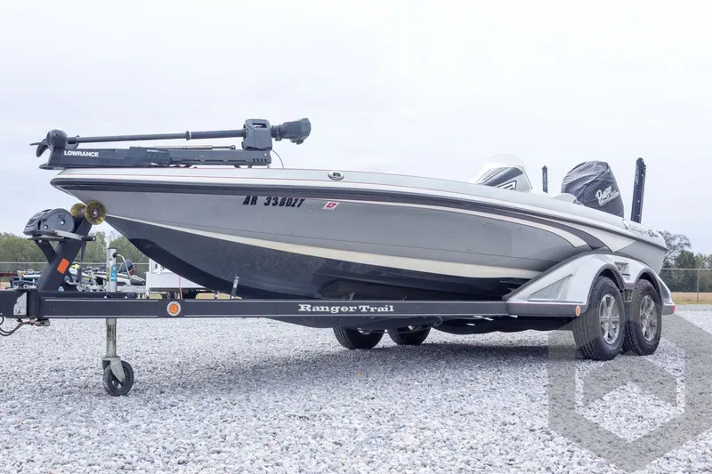 Slide: The Image of 2014 Ranger Z520 Comanche boat on trailer, featuring Lowrance equipment, parked on gravel. - 13