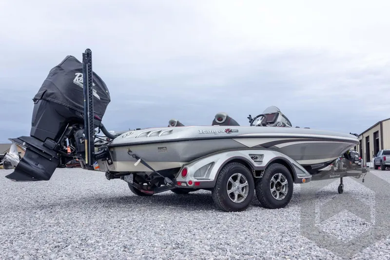 Slide: The Image of 2014 Ranger Z520 Comanche boat on trailer, parked on gravel lot. - 17