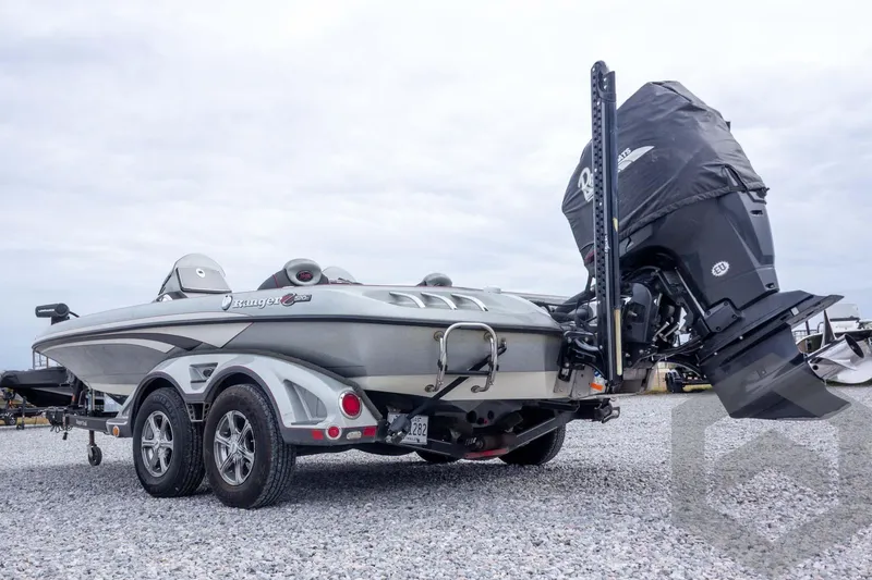 Slide: The Image of 2014 Ranger Z520 Comanche boat on trailer, rear view, parked on gravel. - 19