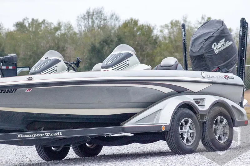 Slide: The Image of 2014 Ranger Z520 Comanche boat on trailer, parked outdoors with trees in background. - 2