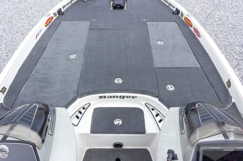 Slide: The Image of 2014 Ranger Z520 Comanche boat deck with storage compartments and carpeted surface. - 33
