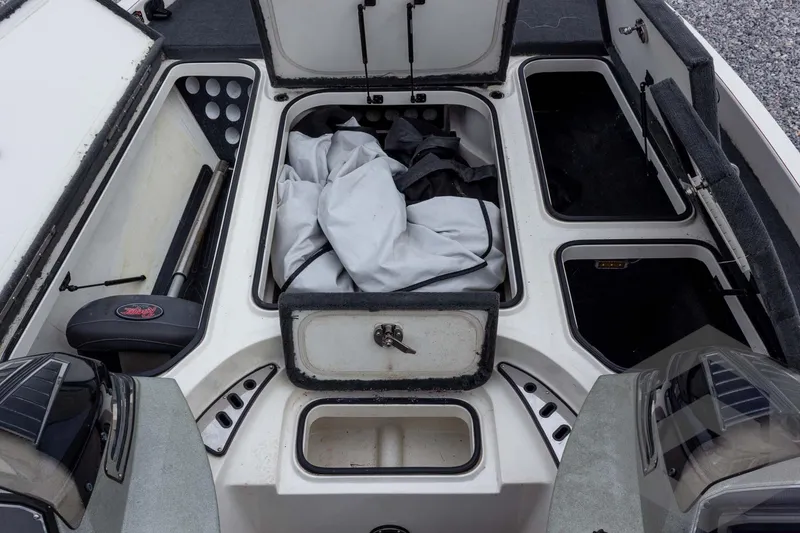 Slide: The Image of 2014 Ranger Z520 Comanche boat storage compartments with open hatches and equipment. - 34