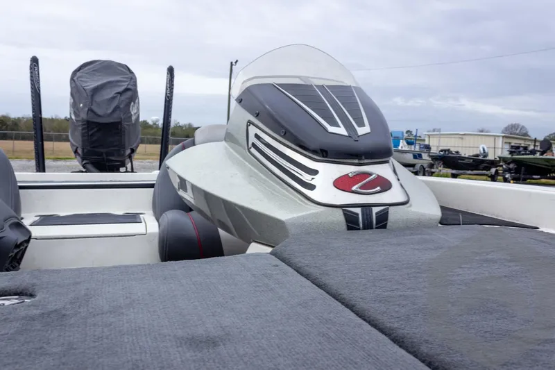 Slide: The Image of 2014 Ranger Z520 Comanche boat with sleek design and covered engine, parked outdoors. - 40