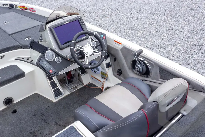 Slide: The Image of 2014 Ranger Z520 Comanche boat cockpit with steering wheel and control panel. - 43