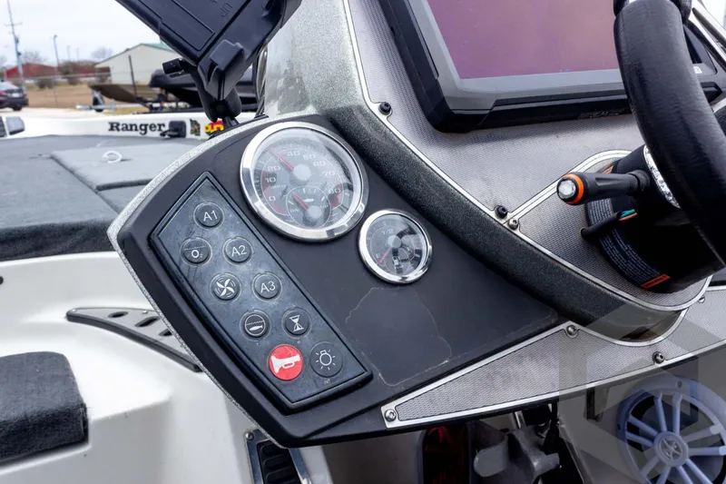 Slide: The Image of Control panel of a 2014 Ranger Z520 Comanche boat with gauges and buttons. - 45