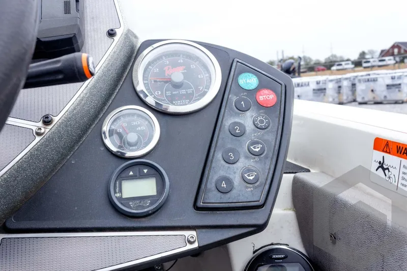 Slide: The Image of Dashboard of a 2014 Ranger Z520 Comanche boat with gauges and control buttons. - 46