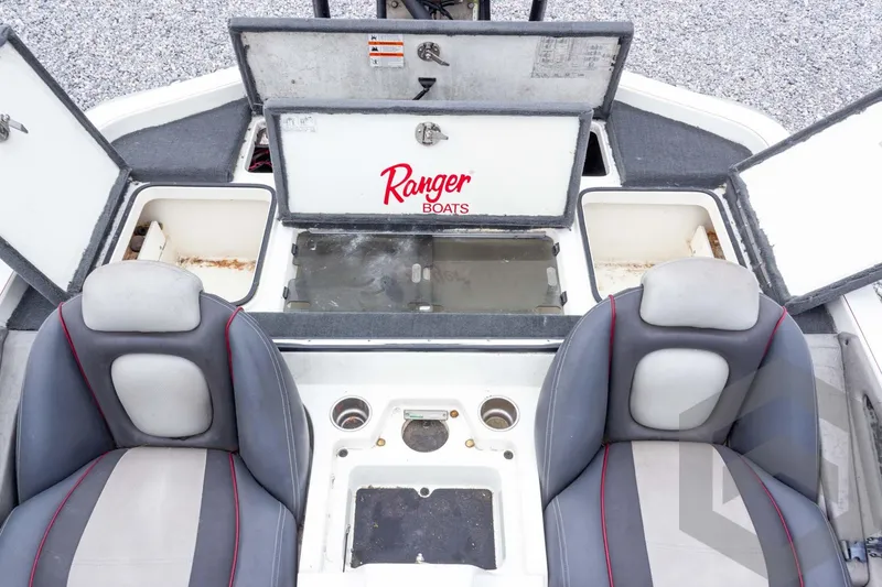 Slide: The Image of 2014 Ranger Z520 Comanche boat interior with open storage compartments and seating. - 52