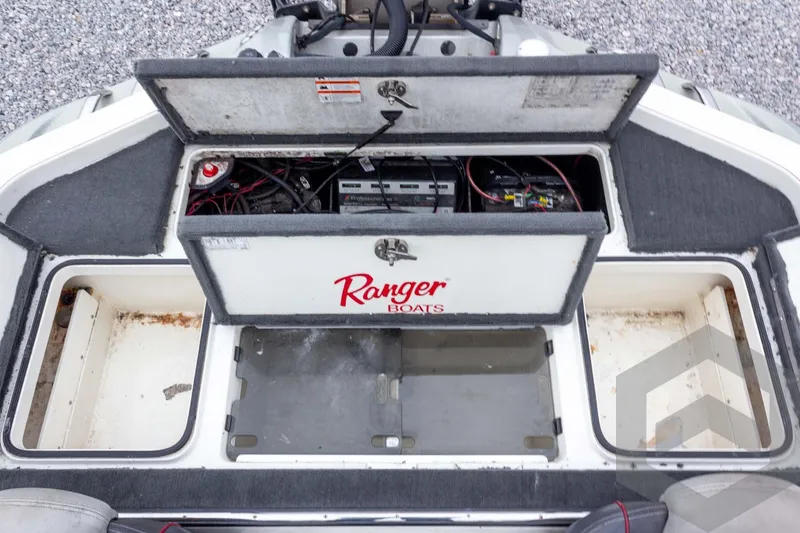 Slide: The Image of 2014 Ranger Z520 Comanche boat storage compartments and battery area. - 53