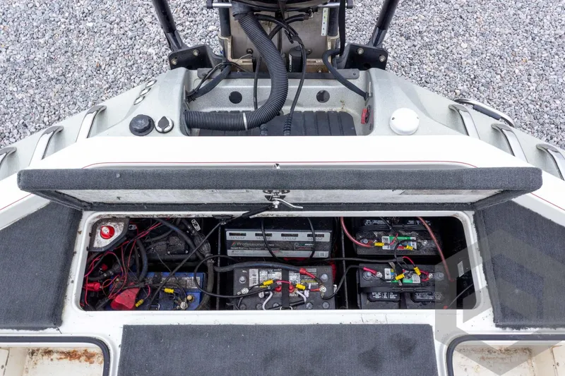 Slide: The Image of 2014 Ranger Z520 Comanche boat battery compartment with wiring and components. - 54