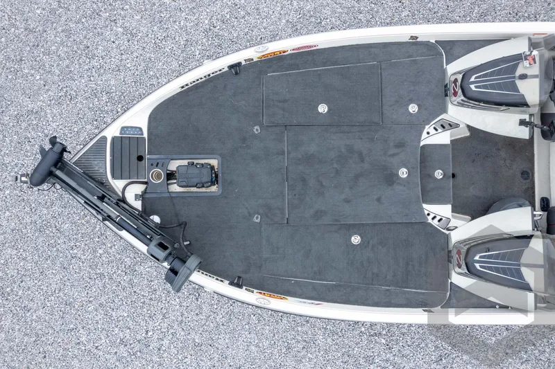 Slide: The Image of 2014 Ranger Z520 Comanche boat deck with trolling motor, viewed from above on gravel surface. - 56