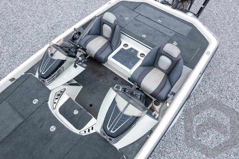 Slide: The Image of 2014 Ranger Z520 Comanche boat interior with dual seats and control panels on gravel surface. - 59