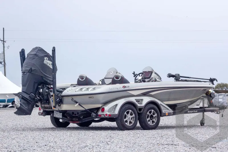 Slide: The Image of 2014 Ranger Z520 Comanche boat on trailer, parked on gravel lot. - 7