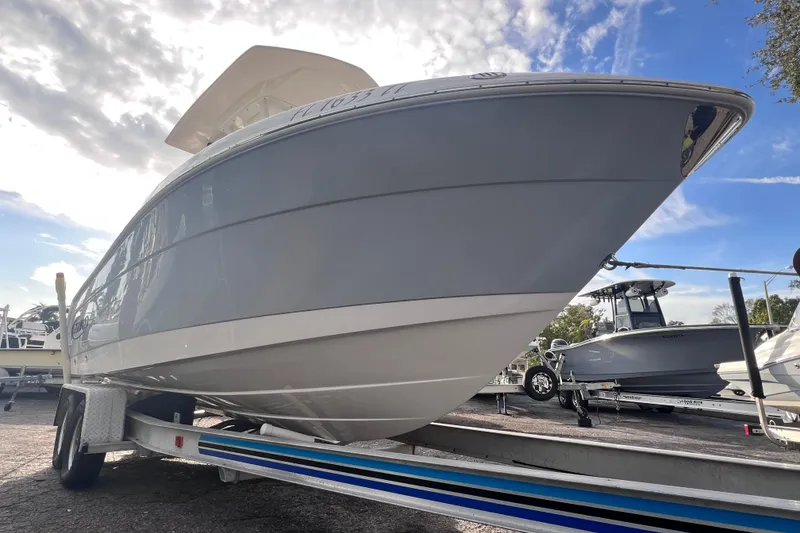 Slide: The Image of 2023 Robalo R222 Explorer boat on trailer under a partly cloudy sky. - 11
