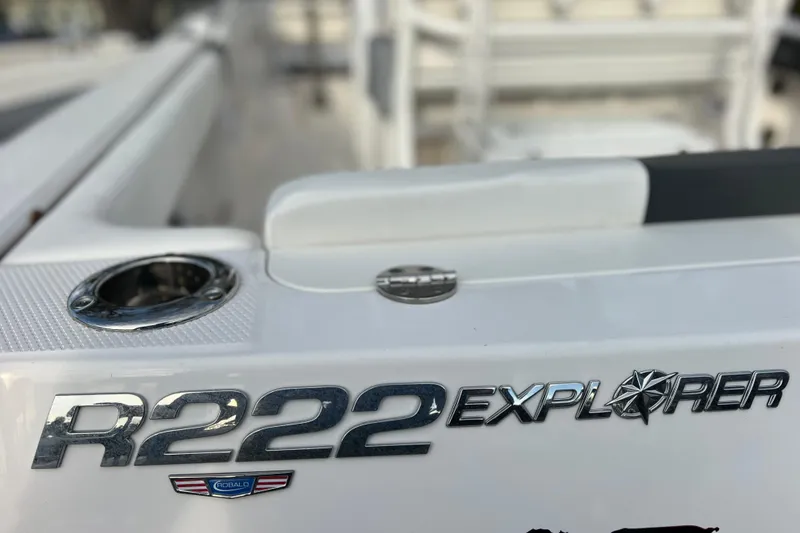 Slide: The Image of 2023 Robalo R222 Explorer boat emblem with sleek design details. - 12