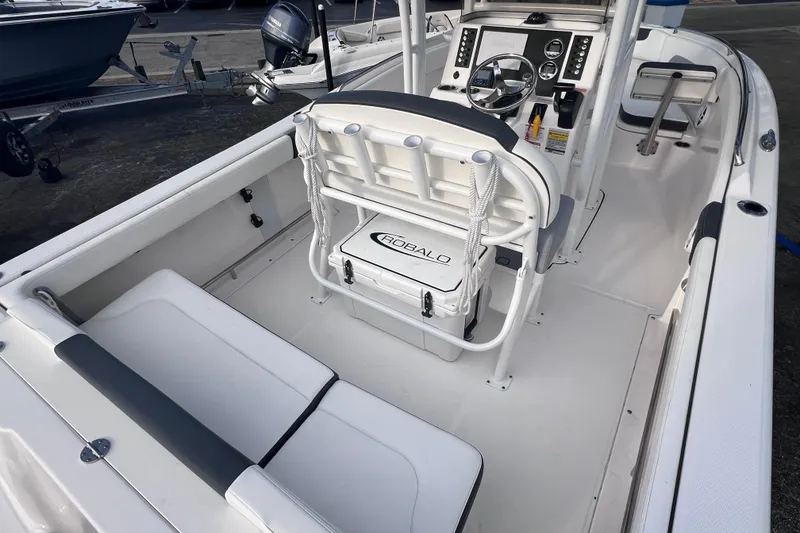 Slide: The Image of 2023 Robalo R222 Explorer boat interior with seating and control console. - 14