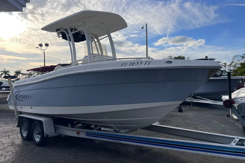 Slide: The Image of 2023 Robalo R222 Explorer boat on trailer under a partly cloudy sky. - 2