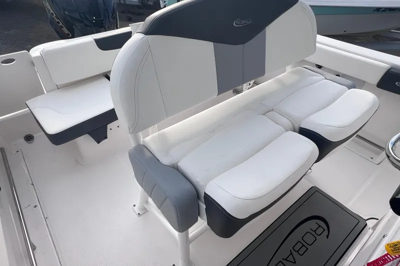 Slide: The Image of 2023 Robalo R222 Explorer boat interior with white and gray seating. - 24