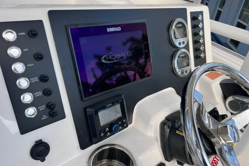 Slide: The Image of 2023 Robalo R222 Explorer dashboard with Simrad display and control panel. - 28