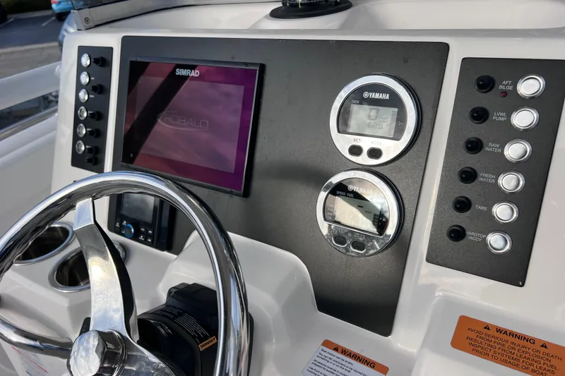 Slide: The Image of 2023 Robalo R222 Explorer dashboard with Simrad display and Yamaha gauges. - 29