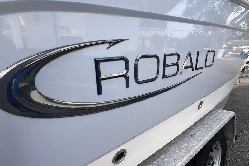 Slide: The Image of 2023 Robalo R222 Explorer boat logo on sleek white hull. - 3