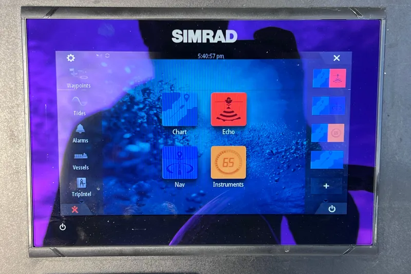 Slide: The Image of Simrad marine display on 2023 Robalo R222 Explorer, showing navigation and echo features. - 33