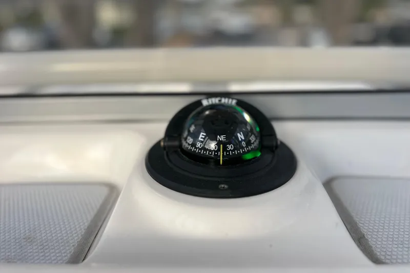 Slide: The Image of Compass on 2023 Robalo R222 Explorer boat dashboard, showing northeast direction. - 36
