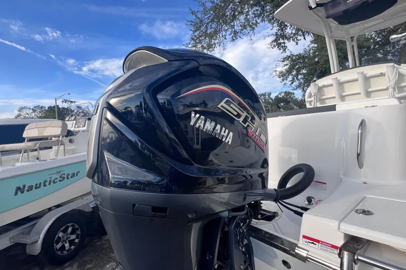 Slide: The Image of 2023 Robalo R222 Explorer with Yamaha outboard motor, parked beside a NauticStar boat. - 4