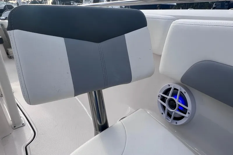 Slide: The Image of 2023 Robalo R222 Explorer boat seat with speaker, featuring blue LED lighting. - 44