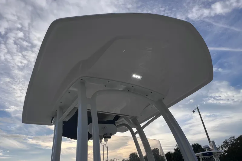 Slide: The Image of 2023 Robalo R222 Explorer boat T-top against a cloudy sky. - 47