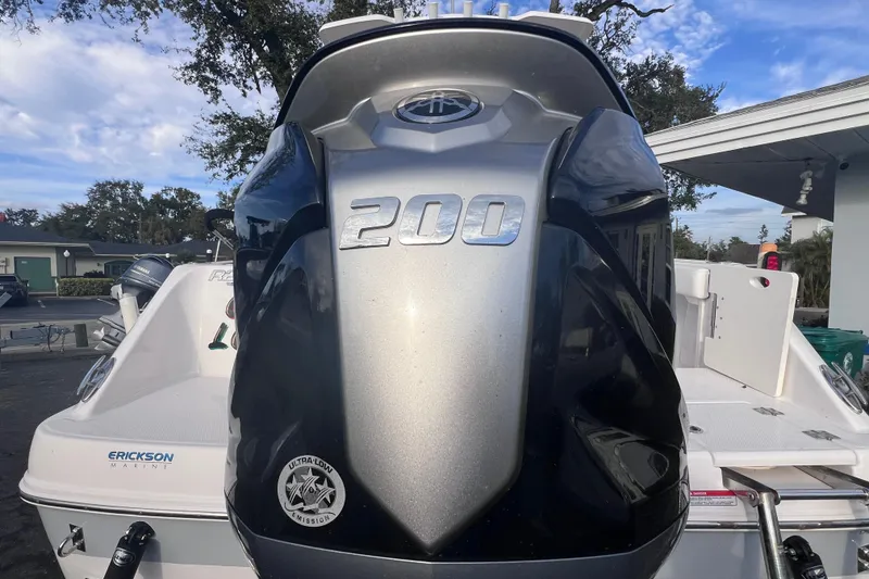 Slide: The Image of 2023 Robalo R222 Explorer boat with powerful 200 HP engine, parked outdoors. - 5
