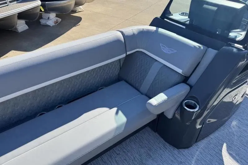 Slide: The Image of 2025 Bennington 26 MSB-ESP boat interior with gray seating and cup holder. - 12