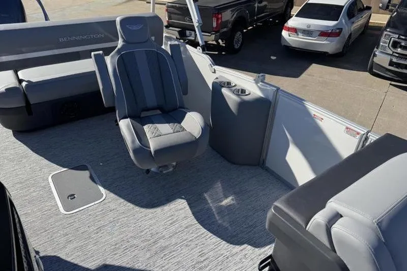 Slide: The Image of 2025 Bennington 26 MSB-ESP boat interior with gray seating and cup holders. - 15