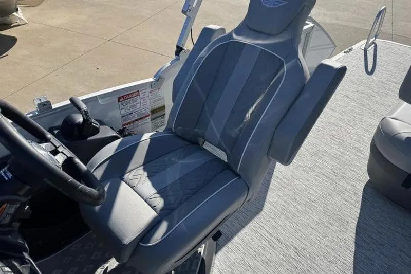 Slide: The Image of 2025 Bennington 26 MSB-ESP boat seat with gray upholstery and steering wheel. - 16