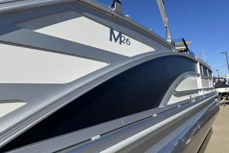 Slide: The Image of 2025 Bennington 26 MSB-ESP boat side view with sleek design and M26 logo. - 25