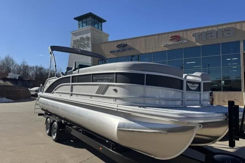 Slide: The Image of 2025 Bennington 26 MSB-ESP pontoon boat on trailer outside dealership. - 3