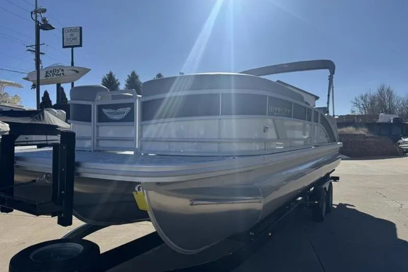 Slide: The Image of 2025 Bennington 26 MSB-ESP pontoon boat on trailer under bright sunlight. - 6