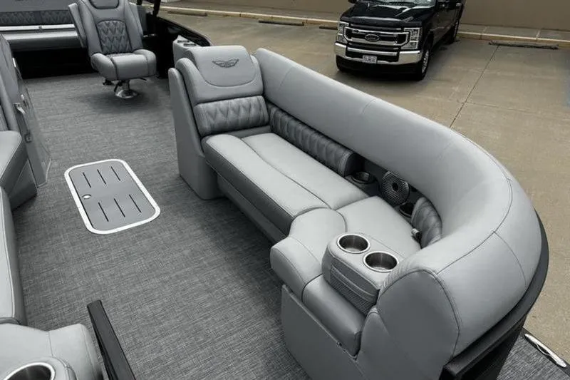 Slide: The Image of 2025 Bennington 26 LXSSBA boat interior with luxurious gray seating and cup holders. - 10