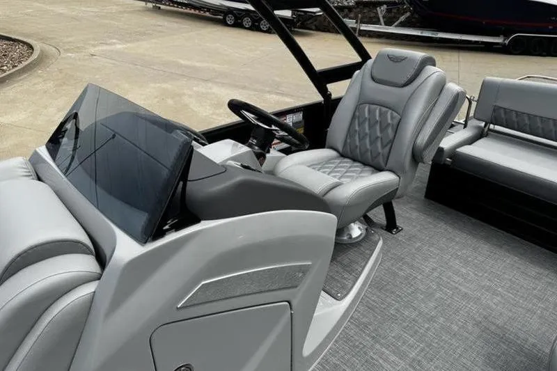 Slide: The Image of 2025 Bennington 26 LXSSBA boat interior with luxurious seating and modern dashboard. - 14