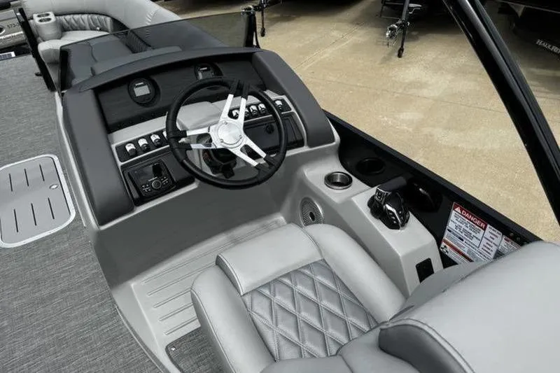 Slide: The Image of 2025 Bennington 26 LXSSBA boat interior with modern steering console and luxurious seating. - 16