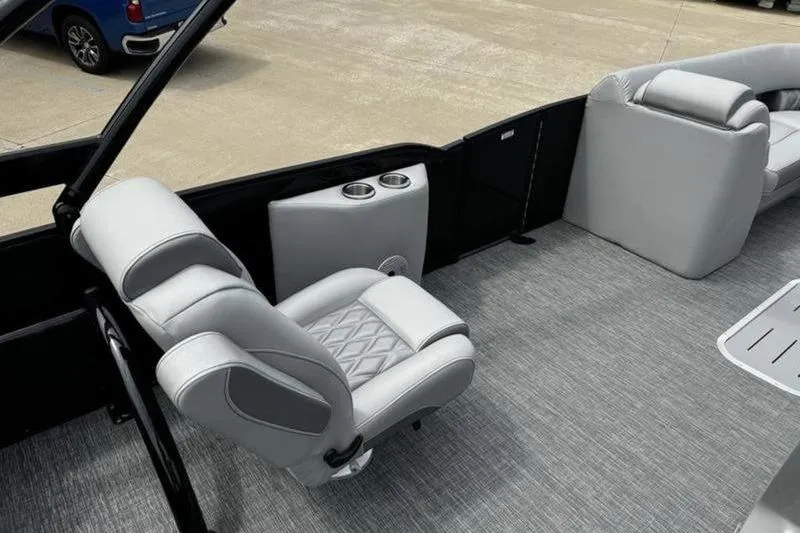Slide: The Image of 2025 Bennington 26 LXSSBA boat interior with gray seating and cup holders. - 17