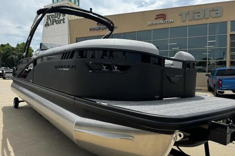 Slide: The Image of 2025 Bennington 26 LXSSBA pontoon boat displayed at dealership. - 3