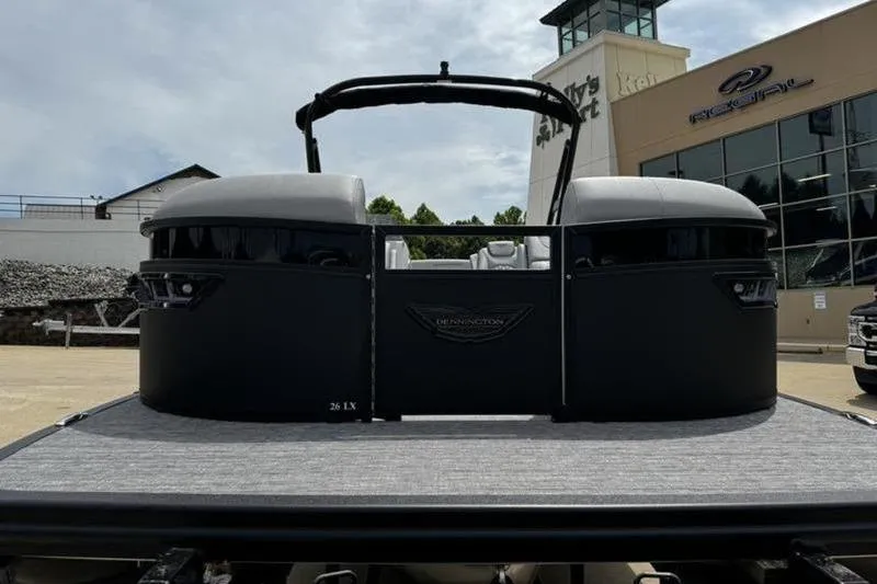 Slide: The Image of 2025 Bennington 26 LXSSBA pontoon boat at dealership, front view. - 4