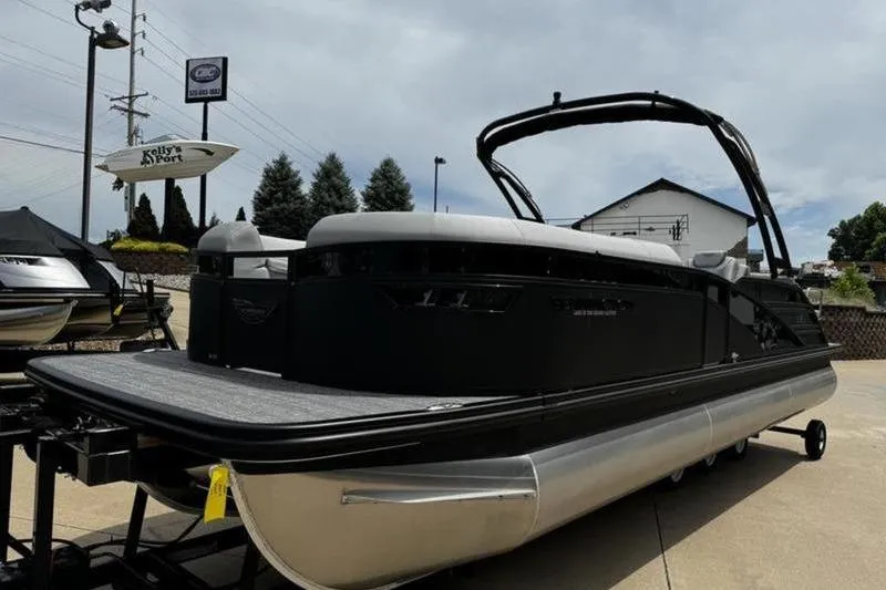 Slide: The Image of 2025 Bennington 26 LXSSBA pontoon boat displayed outdoors on a trailer. - 5
